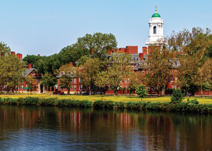 Historic university campus buildings along a river featured in the LiquiTech Northeast University case study