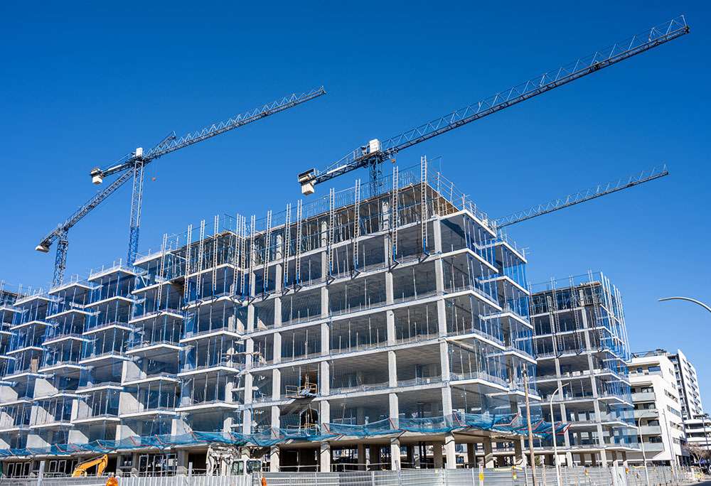 Multi-story building under construction with cranes on the LiquiTech New Construction page