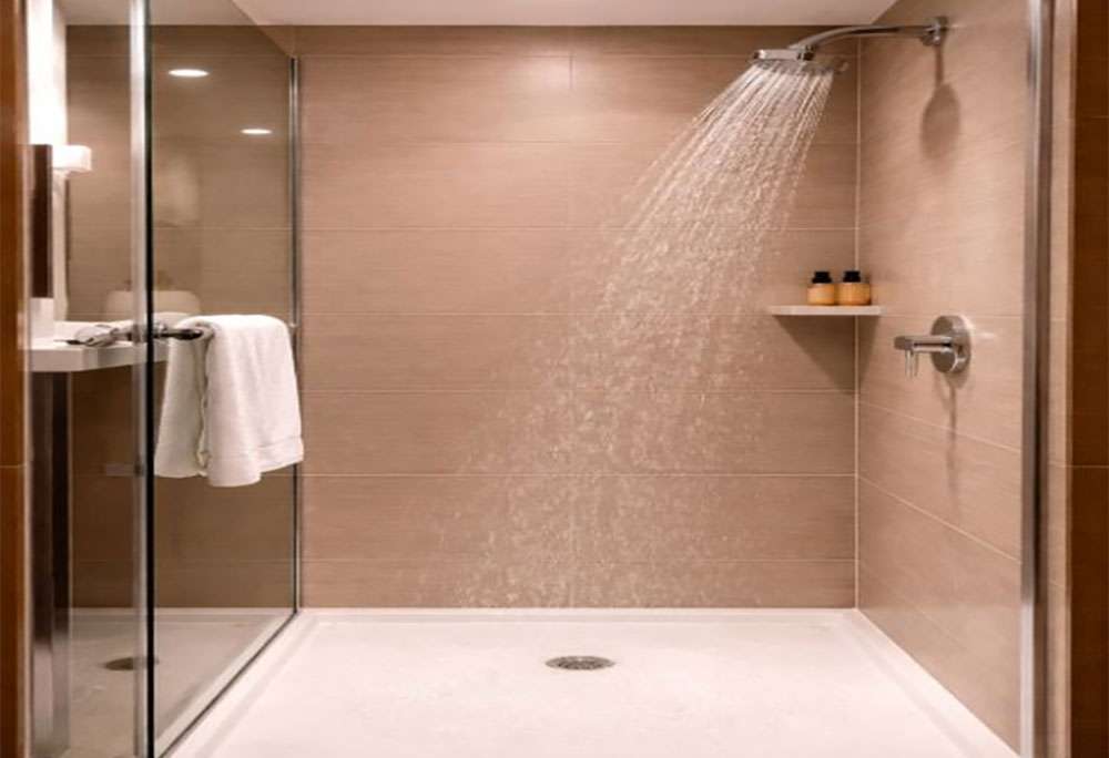 Modern hotel bathroom with a glass-enclosed shower, featured on the LiquiTech Hospitality page