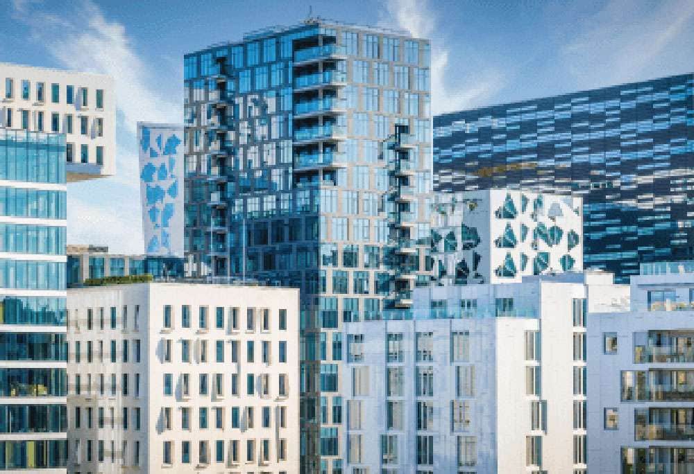 Modern glass office towers reflecting city skyline, representing commercial real estate water management